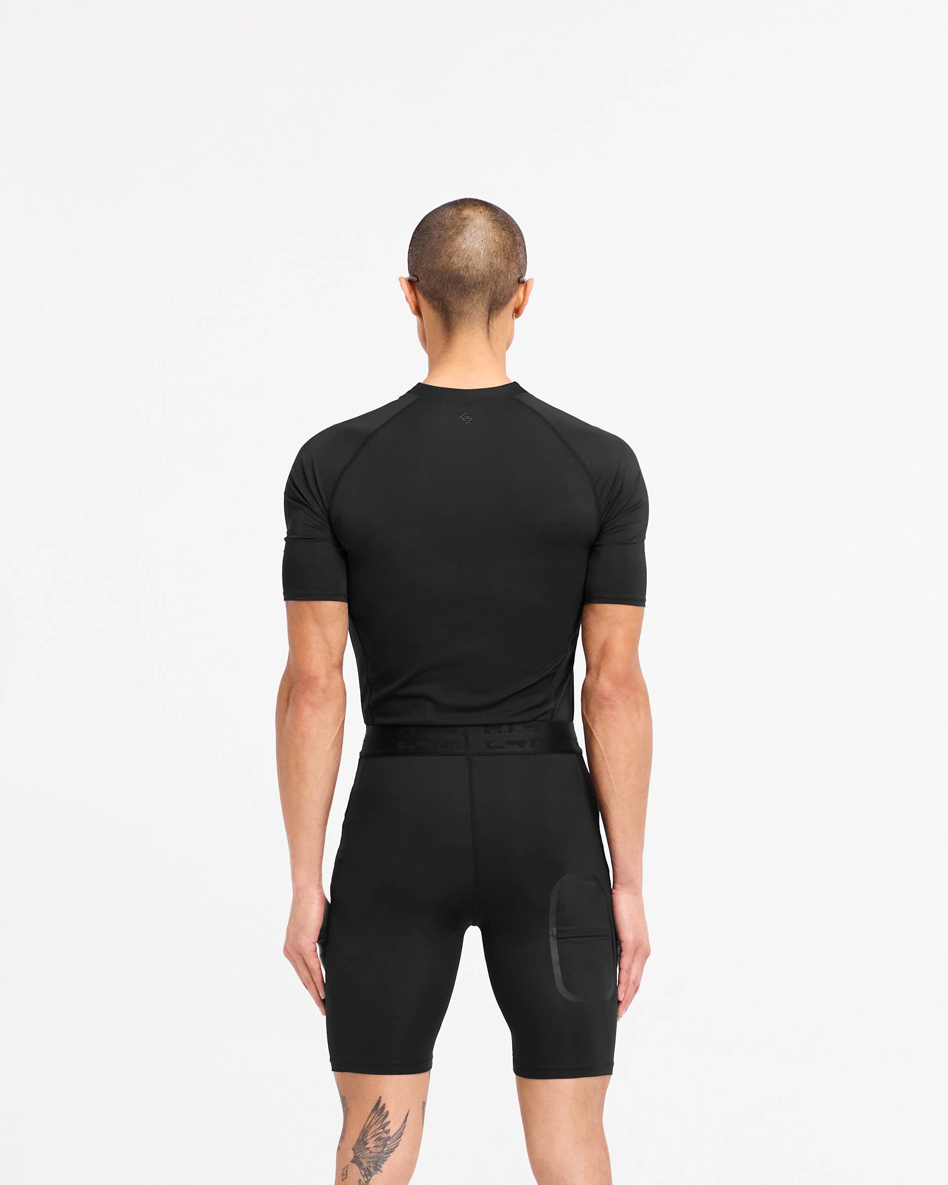 Man wearing a black t-shirt on a plain white background | 247 Compound T-Shirt in Black | T-Shirt with raglan sleeves and flatlock stitching | 247 T-Shirts | Represent Clo